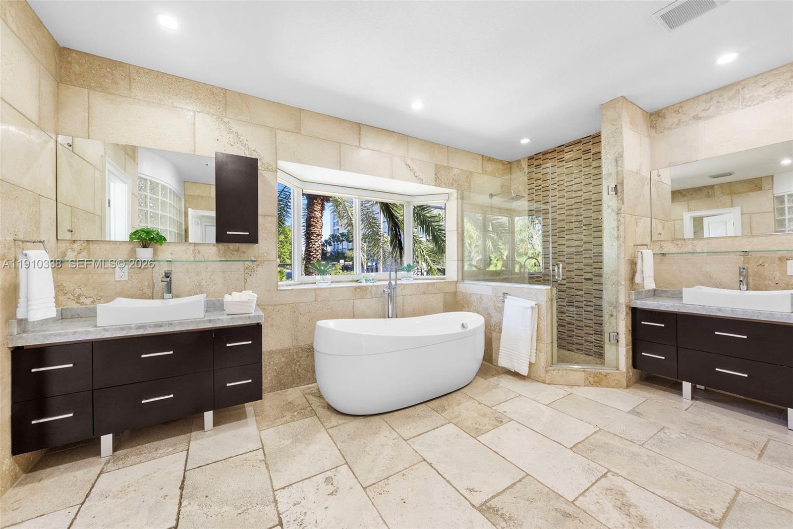 6300 Allison Road Miami Beach, FL 33141 - Photo 27 of 43 a spacious bathroom with a tub sink and mirror