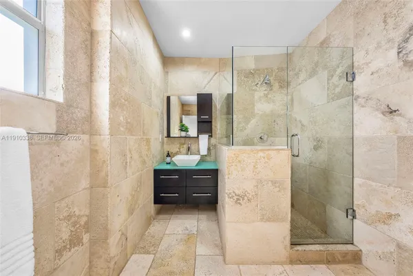 a bathroom with a glass shower door