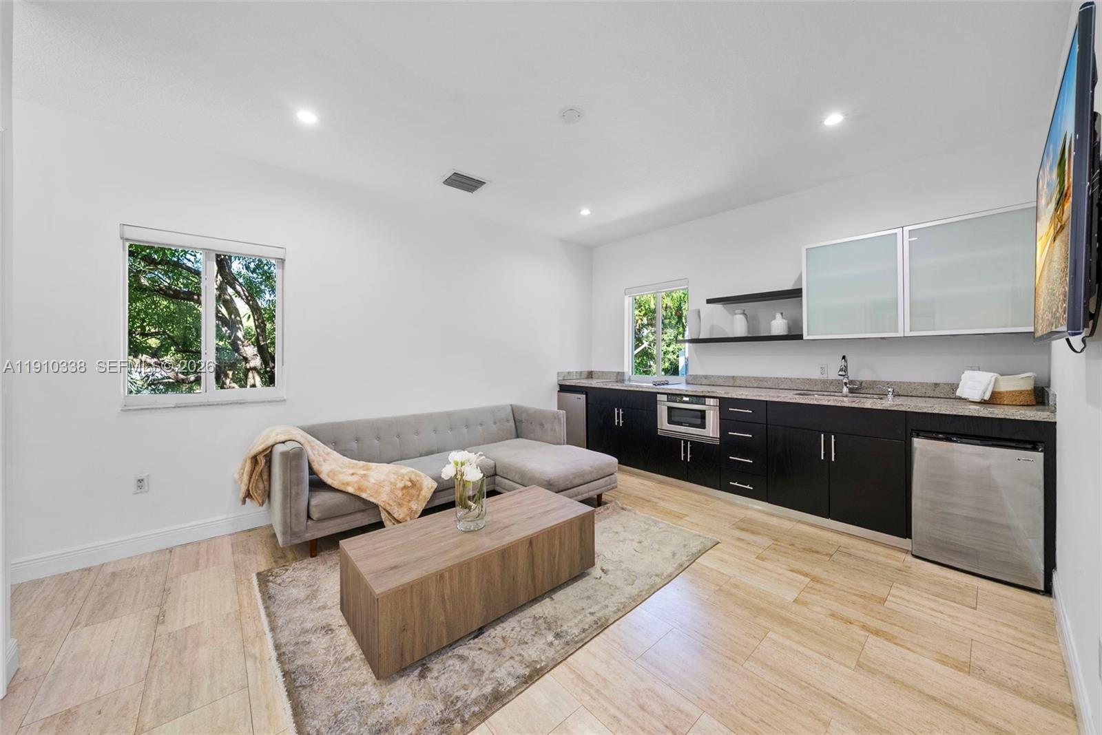 6300 Allison Road Miami Beach, FL 33141 - Photo 32 of 43 a living room with stainless steel appliances granite countertop furniture and a wooden floor