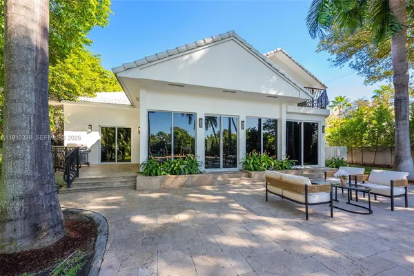 a view of a house with backyard and sitting area