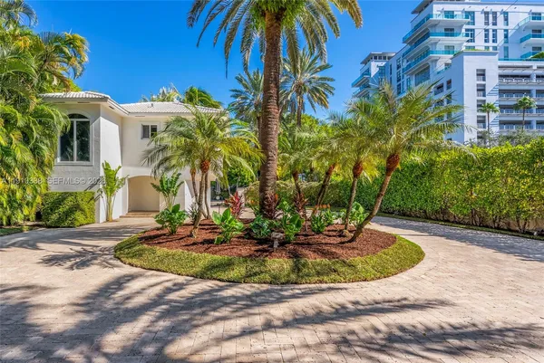 a view of a palm trees front of house