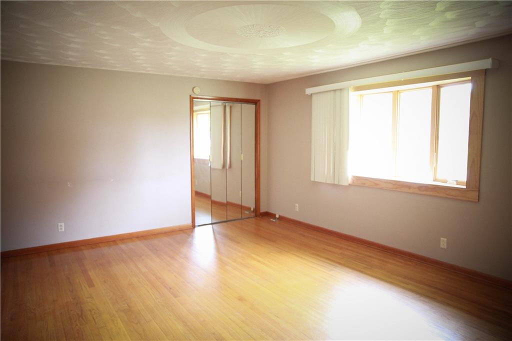 101 East End Road Connellsville, PA 15425 - Photo 14 of 23 an empty room with wooden floor and windows