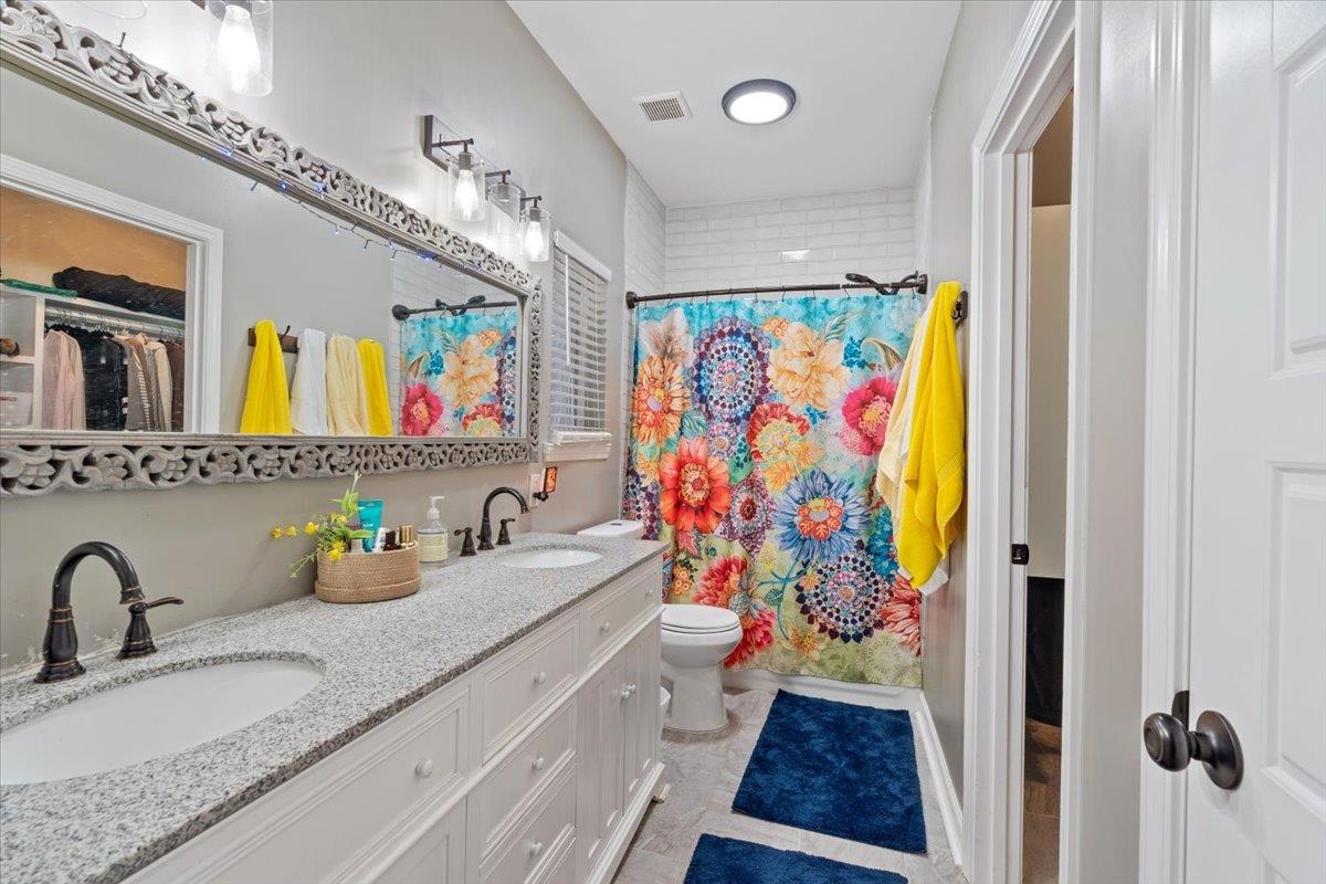 110 Rolling Acres Drive Eads, TN 38028 - Photo 21 of 23 a bathroom with a sink mirror and a shower curtain