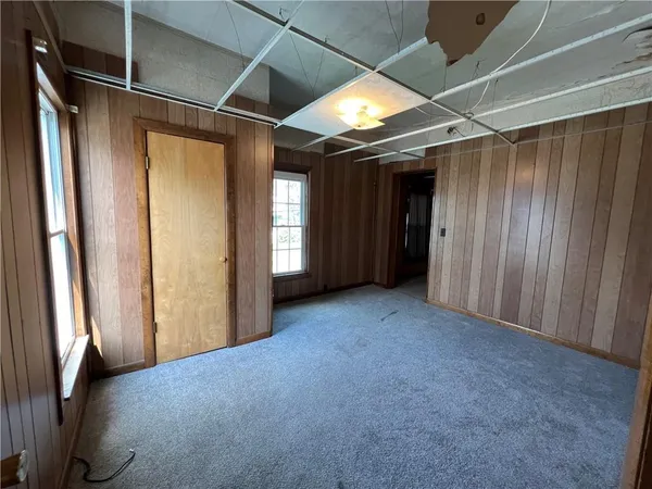 a view of empty room with wooden walls