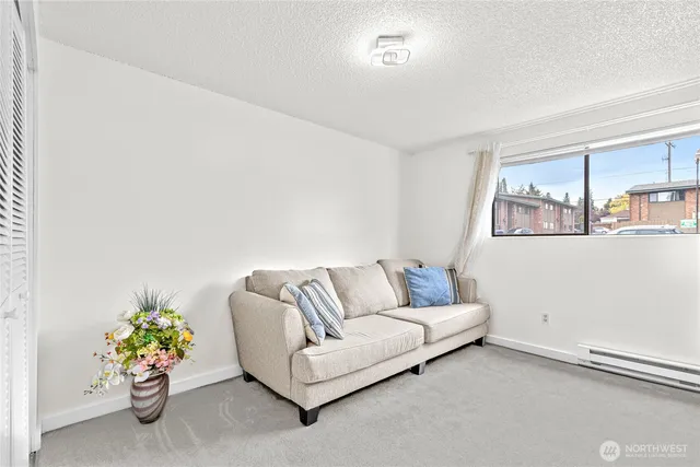 a living room with furniture flowerpot and a window