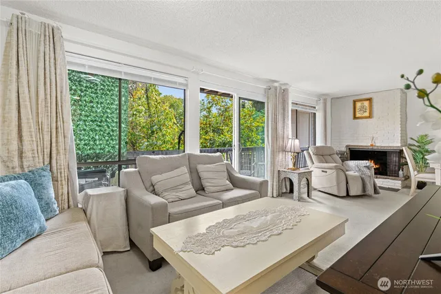 a living room with furniture large window and a table