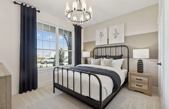 a bedroom with a bed and a chandelier