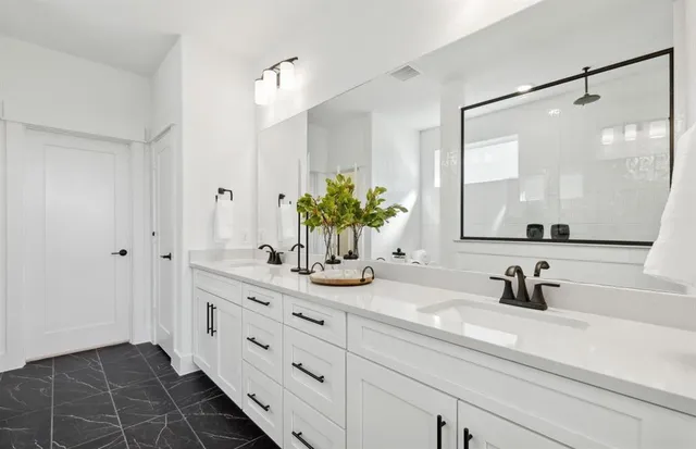 a bathroom with a double vanity sink and a mirror