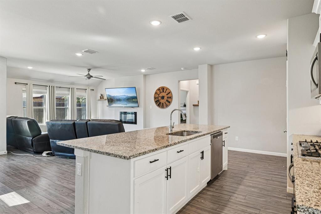 312 Scenic Point Drive Princeton, TX 75407 - Photo 40 of 40 a large kitchen with stainless steel appliances granite countertop a lot of counter space and wooden floor