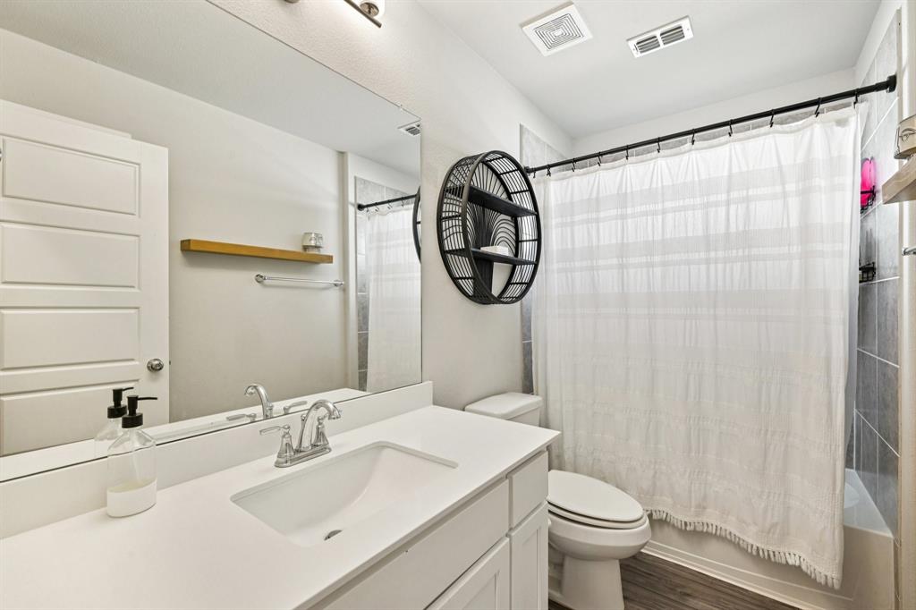 312 Scenic Point Drive Princeton, TX 75407 - Photo 19 of 40 a bathroom with a sink a toilet and a mirror