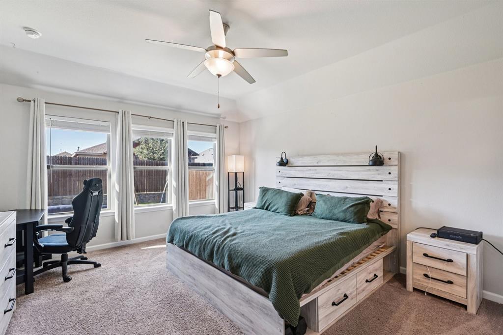 312 Scenic Point Drive Princeton, TX 75407 - Photo 25 of 40 a bedroom with a bed and a chandelier