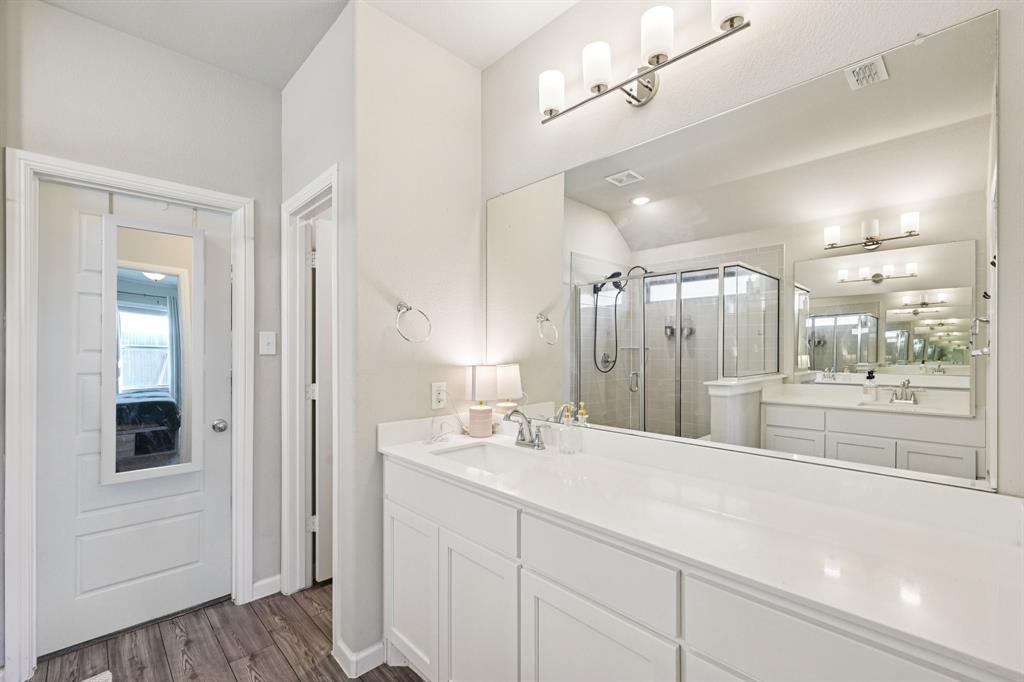 312 Scenic Point Drive Princeton, TX 75407 - Photo 29 of 40 a bathroom with a double vanity sink and mirror