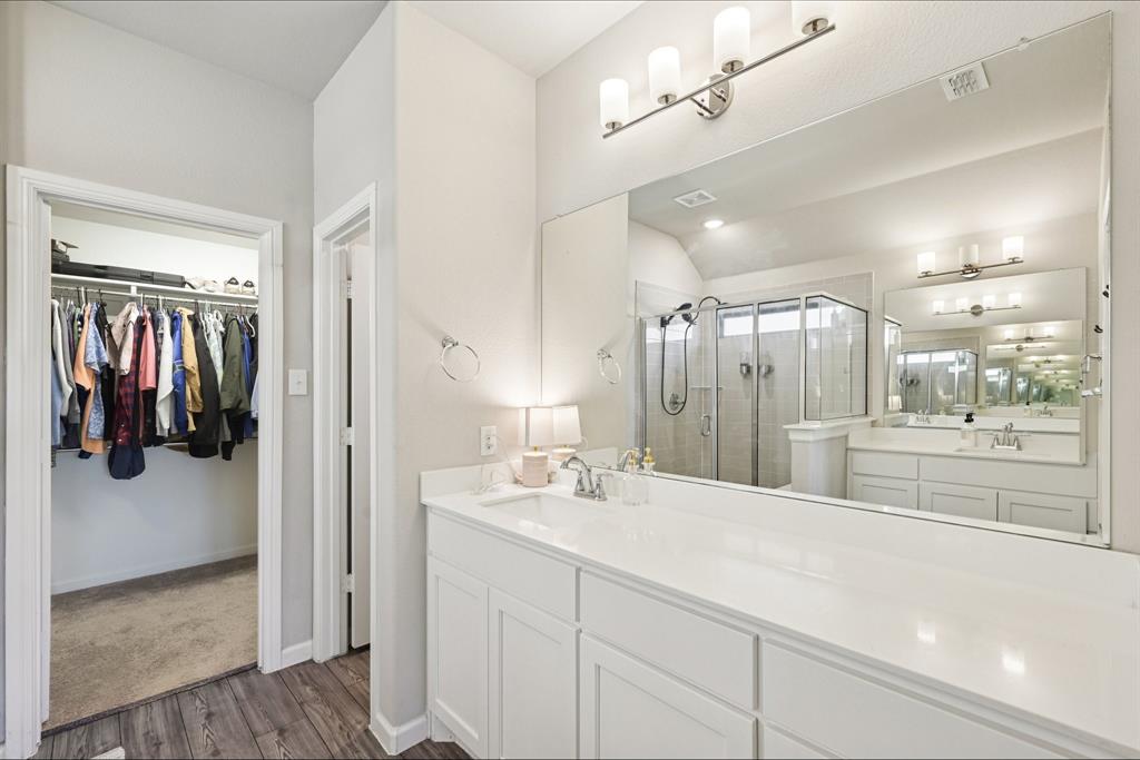 312 Scenic Point Drive Princeton, TX 75407 - Photo 30 of 40 a bathroom with a sink a mirror and shower