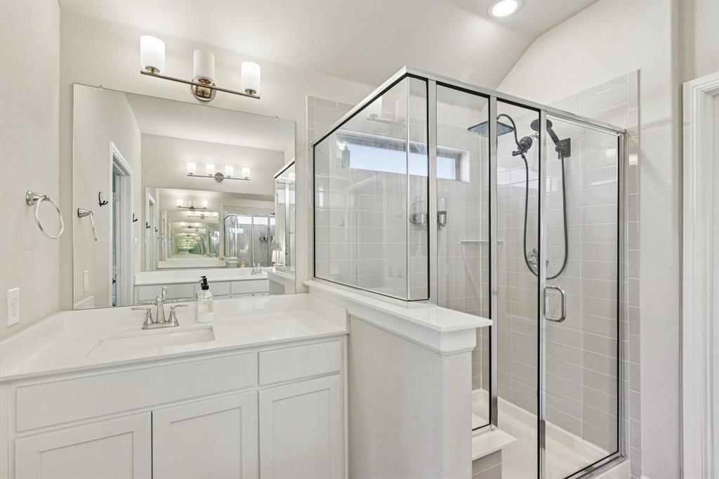 312 Scenic Point Drive Princeton, TX 75407 - Photo 31 of 40 a bathroom with a shower sink and mirror