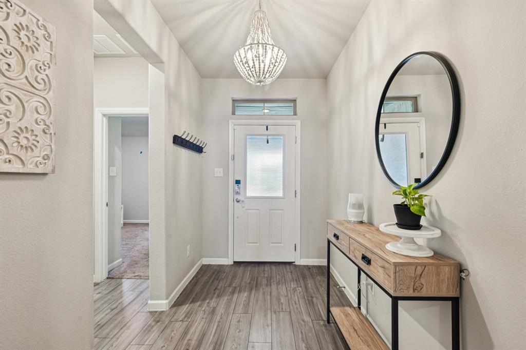 312 Scenic Point Drive Princeton, TX 75407 - Photo 7 of 40 a room with painting on the wall and a mirror