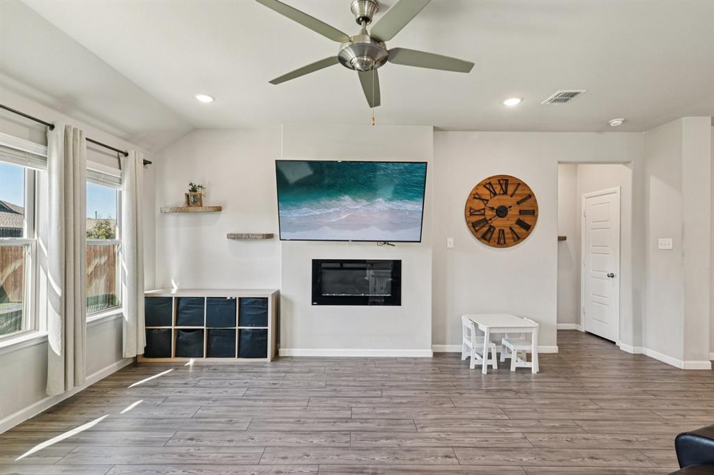 312 Scenic Point Drive Princeton, TX 75407 - Photo 10 of 40 a living room with furniture a flat screen tv and a fireplace