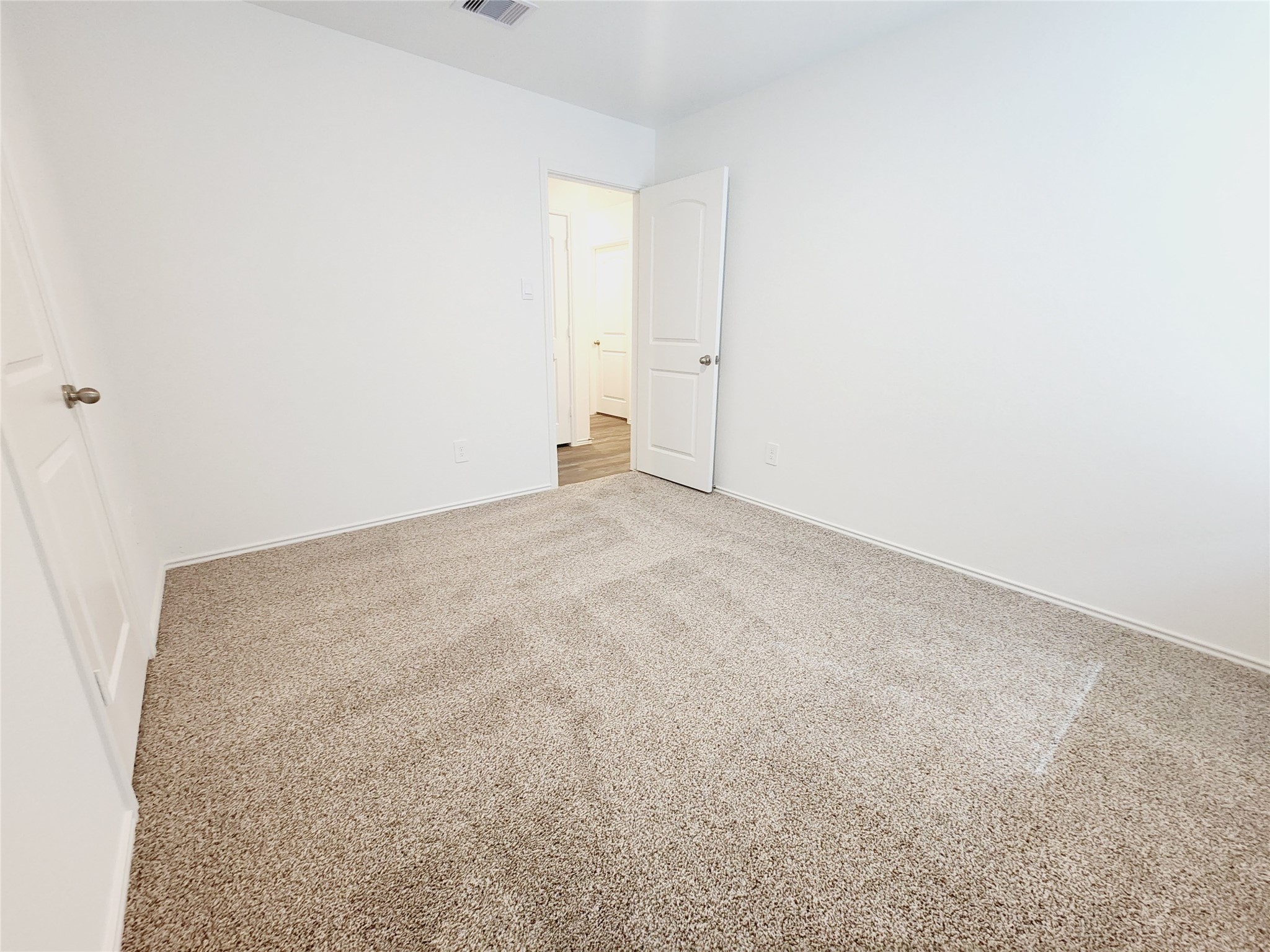 6043 Canyon Dawn Drive Spring, TX 77373 - Photo 21 of 31 This is a bright, room with clean white walls and plush carpet flooring. The space is well-lit and appears ready for customization.