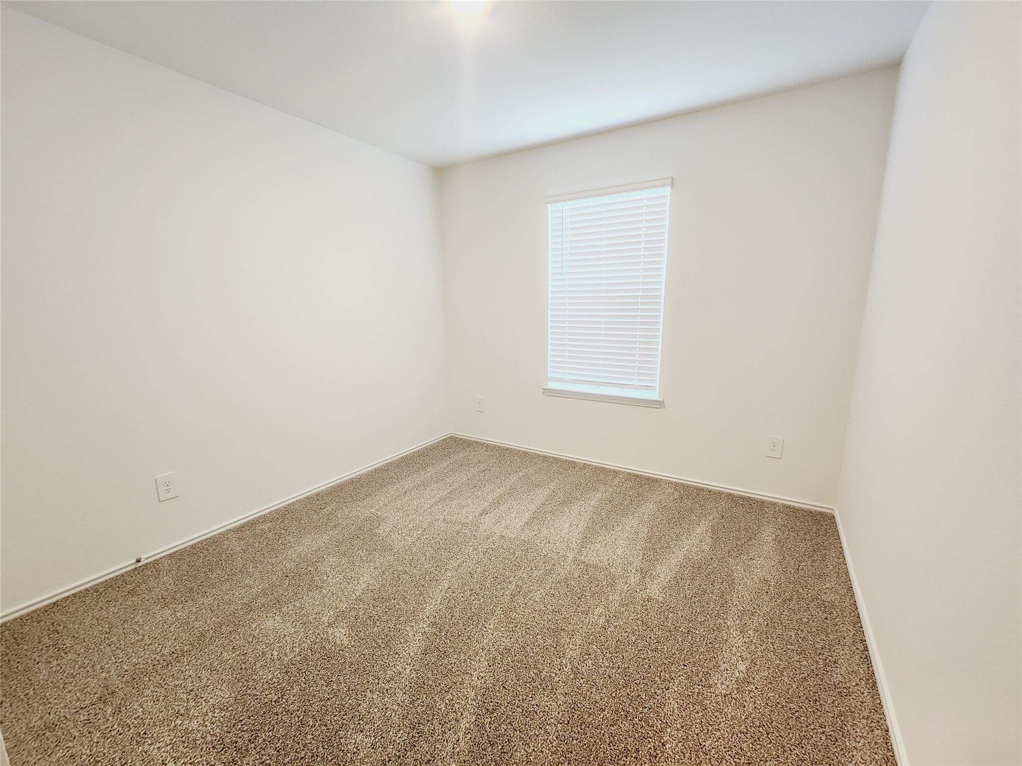 6043 Canyon Dawn Drive Spring, TX 77373 - Photo 24 of 31 bright 3rd room with neutral walls and carpeted flooring. It features a window with blinds, allowing natural light to fill the space, making it ideal for a bedroom or office.