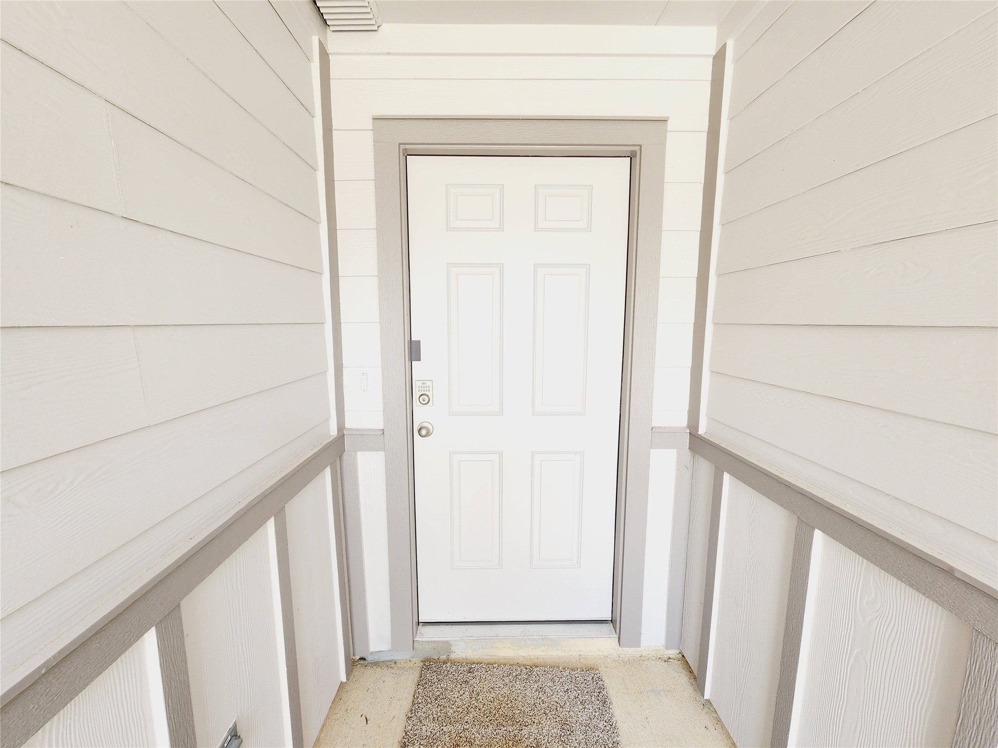 6043 Canyon Dawn Drive Spring, TX 77373 - Photo 6 of 31 a clean, narrow entryway with light siding and a white front door, creating a welcoming and bright entrance to the home.