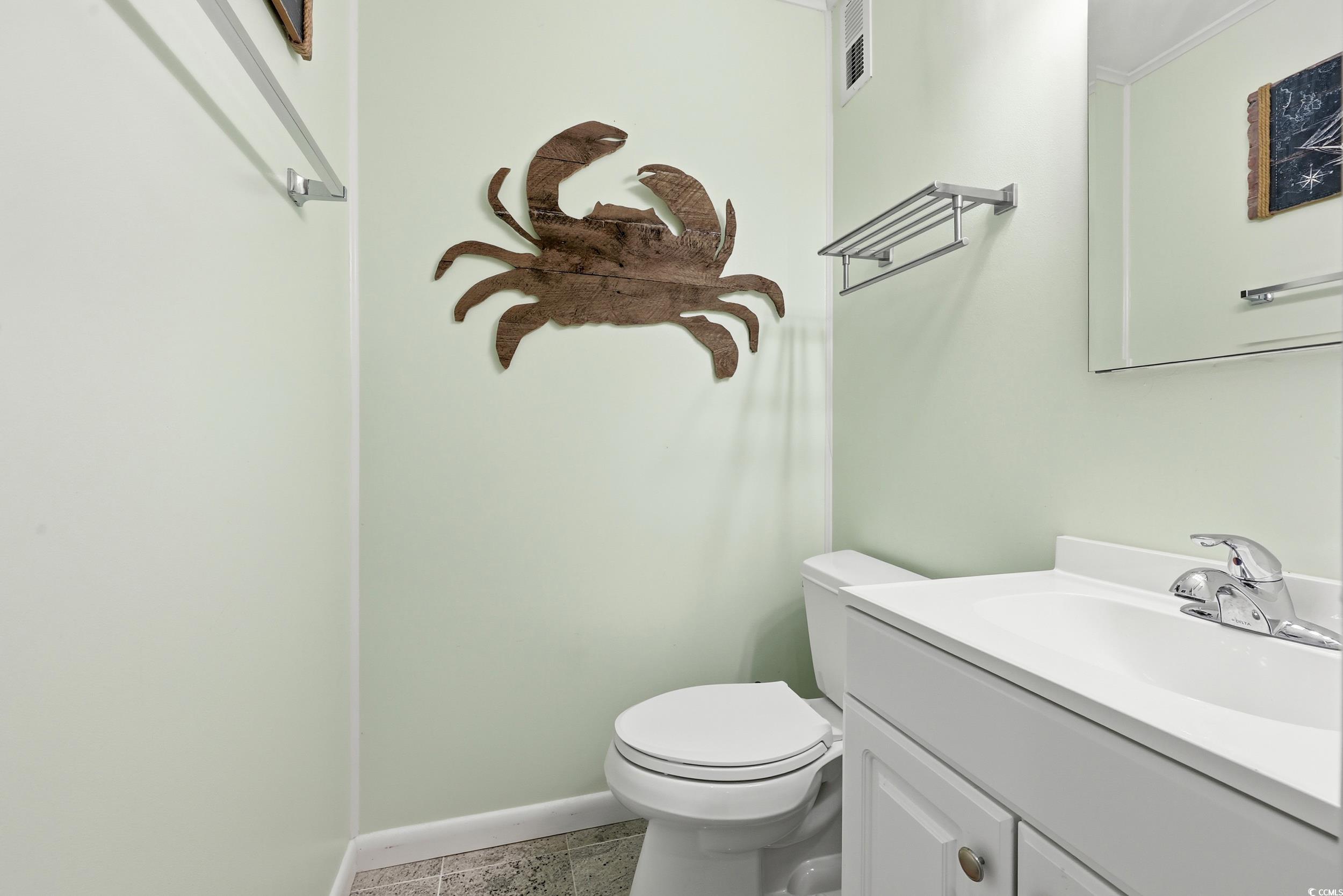 9501 Shore Drive, Unit A208 Myrtle Beach, SC 29572 - Photo 21 of 29 Half bath with vanity and baseboards