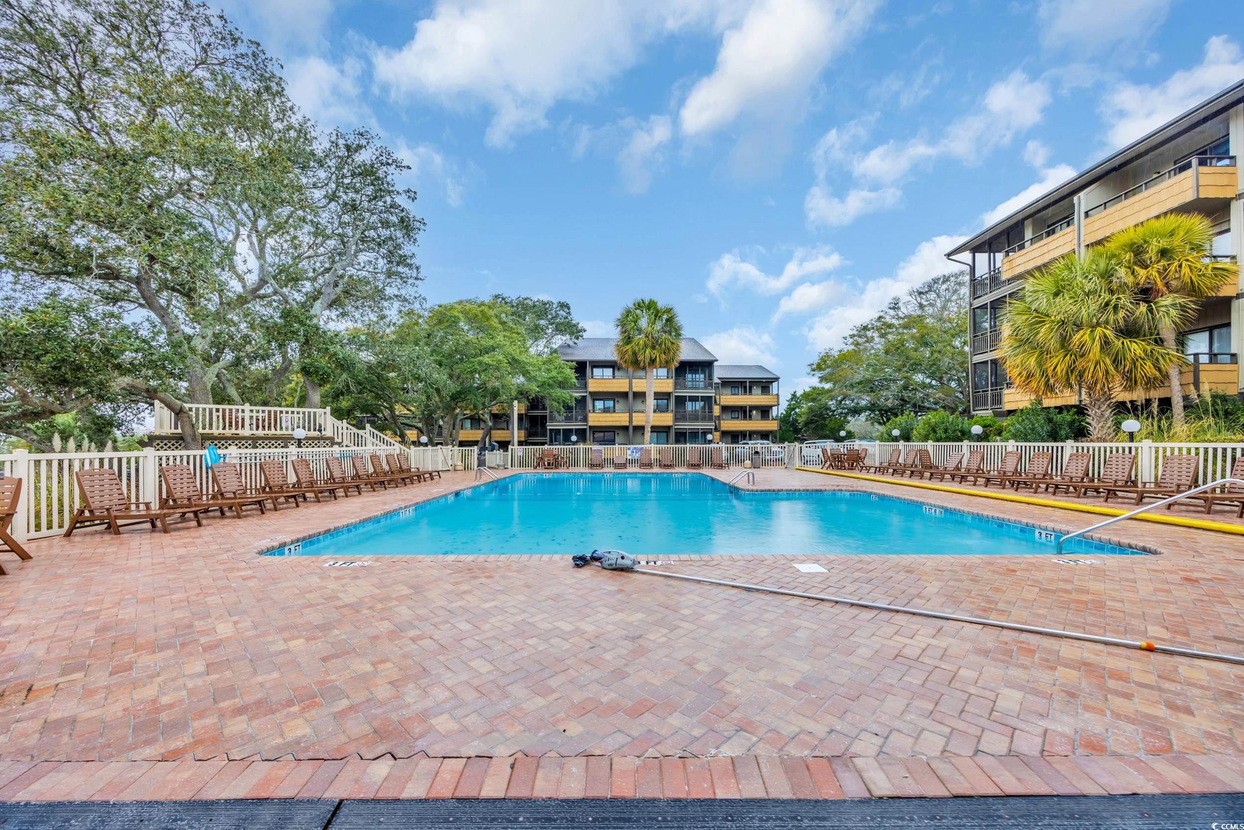 9501 Shore Drive, Unit A208 Myrtle Beach, SC 29572 - Photo 23 of 29 Community pool with a patio