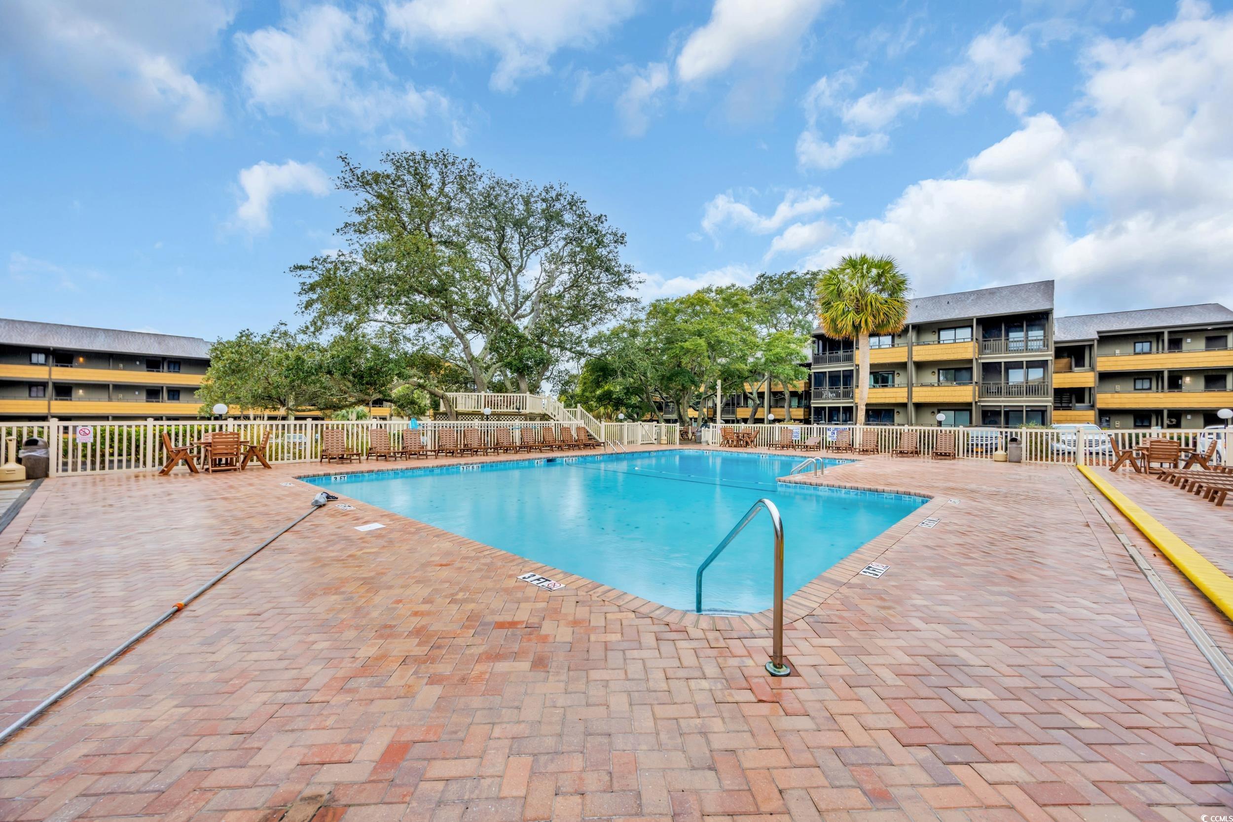 9501 Shore Drive, Unit A208 Myrtle Beach, SC 29572 - Photo 25 of 29 Community pool featuring a patio