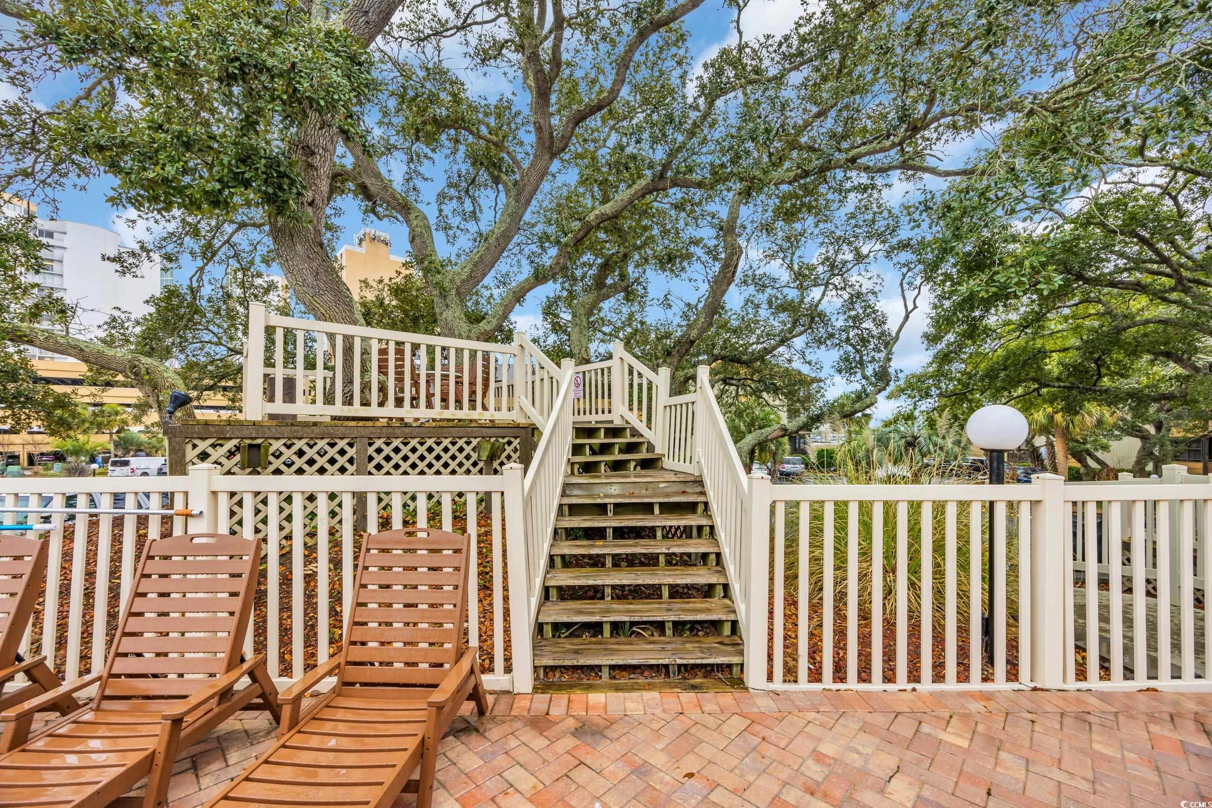 9501 Shore Drive, Unit A208 Myrtle Beach, SC 29572 - Photo 26 of 29 View of patio featuring stairway and a wooden deck