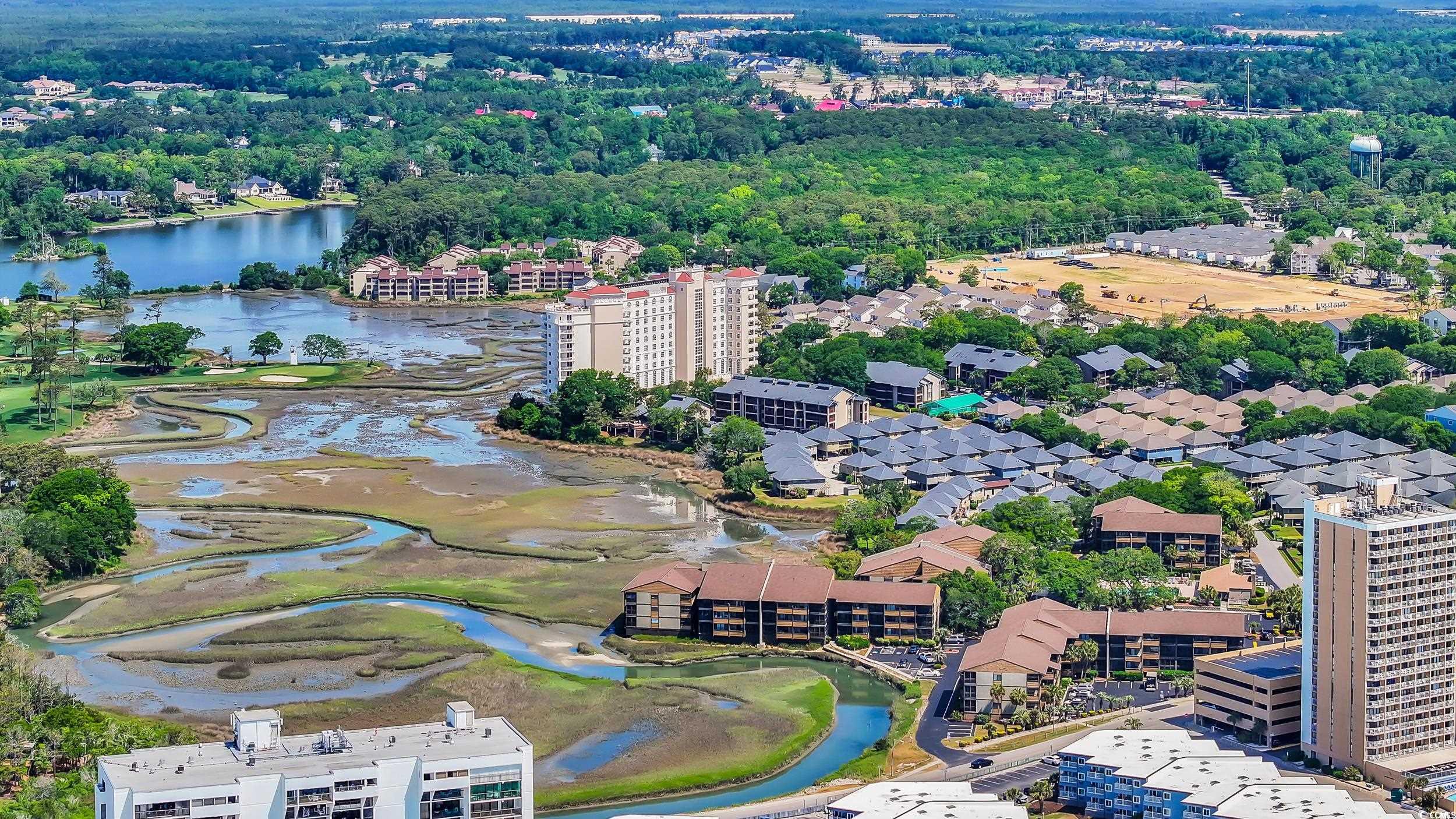 9501 Shore Drive, Unit A208 Myrtle Beach, SC 29572 - Photo 4 of 29 Drone / aerial view of a large body of water and apartment complex