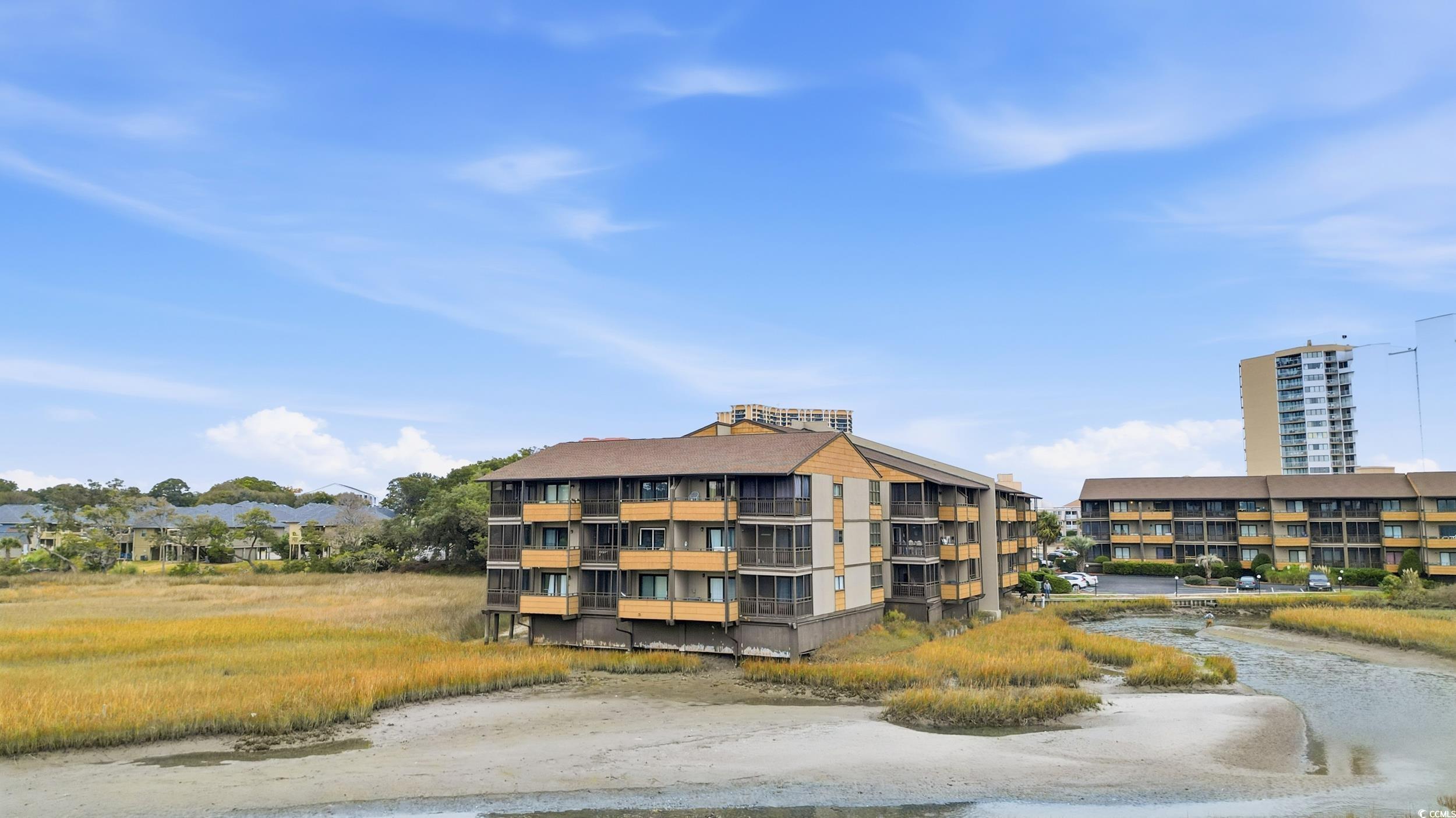 9501 Shore Drive, Unit A208 Myrtle Beach, SC 29572 - Photo 5 of 29 View of apartment building / complex featuring a water view
