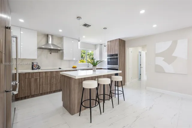a kitchen with a table and chairs in it