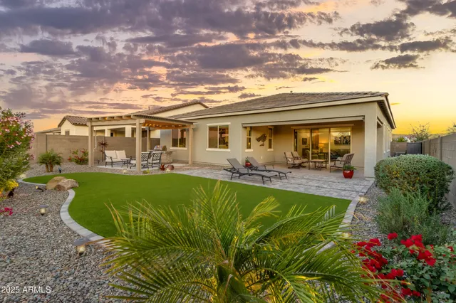 a kitchen with a sink a counter top space and living room view