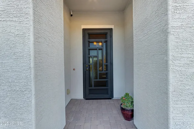 a dining room with furniture a chandelier and window