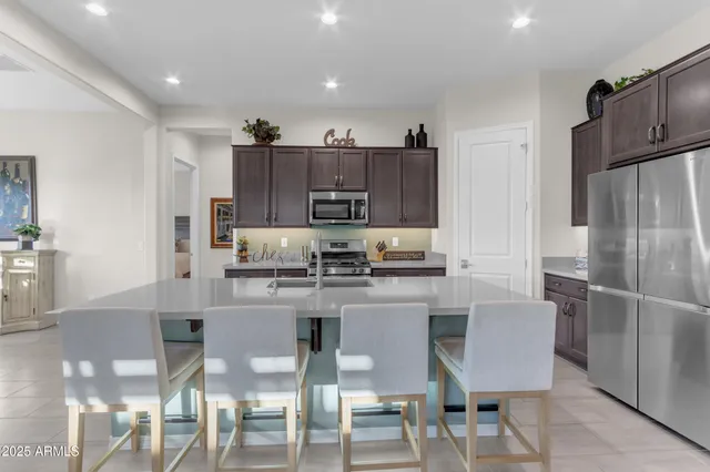 a living room with furniture and kitchen view