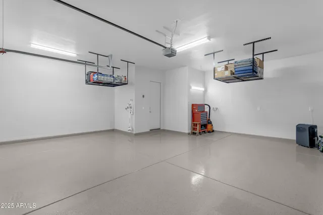 a spacious bathroom with a double vanity sink a toilet a mirror and shower