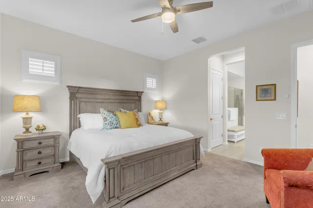 a patio with a table and chairs and potted plants