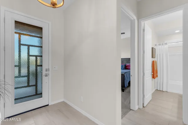 a living room with furniture and floor to ceiling window