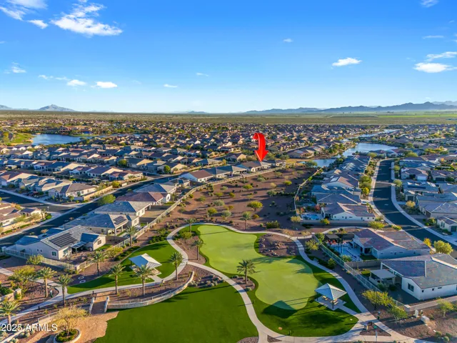 a view of a hallway with wooden floor and a potted plant