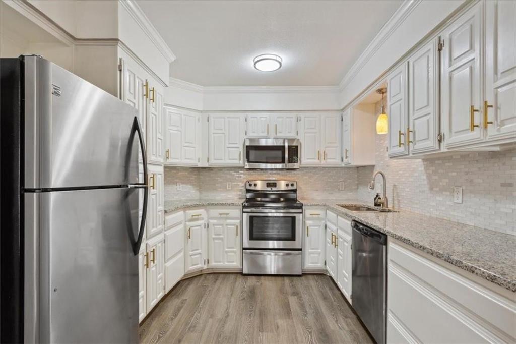 2306 Melissa Drive Waco, TX 76708 - Photo 8 of 22 a kitchen with stainless steel appliances granite countertop a refrigerator stove a sink and dishwasher