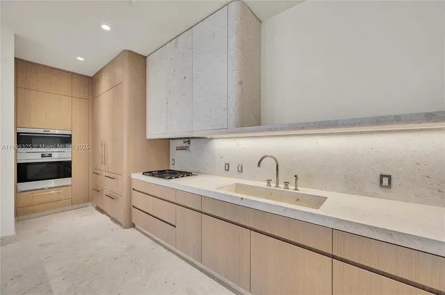 a kitchen with a sink stove and cabinets