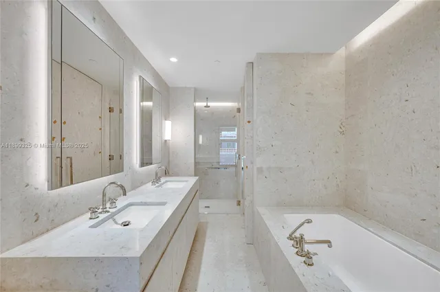 a bathroom with a bathtub shower sink and mirror