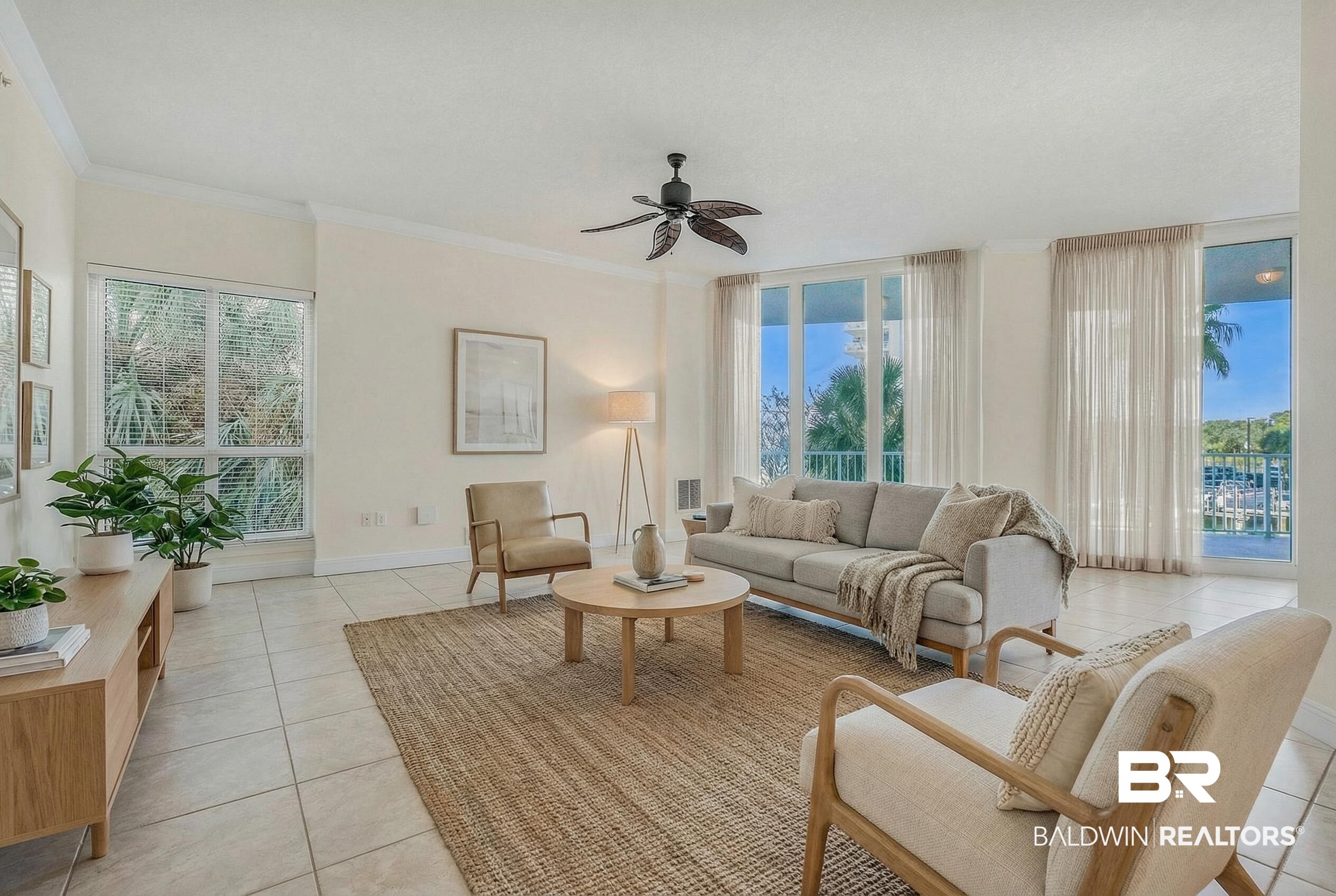 28250 Canal Road, Unit 106 Orange Beach, AL 36561 - Photo 43 of 50 Living area with light tile patterned flooring, ornamental molding, a ceiling fan, and healthy amount of natural light
