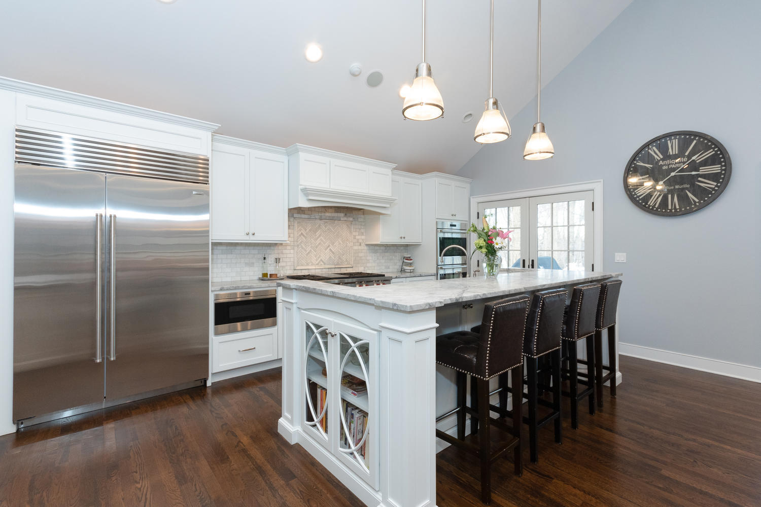 14 Deerfield Road Darien, CT 06820 - Photo 14 of 55 a kitchen with granite countertop a refrigerator a stove a dining table and chairs with wooden floor
