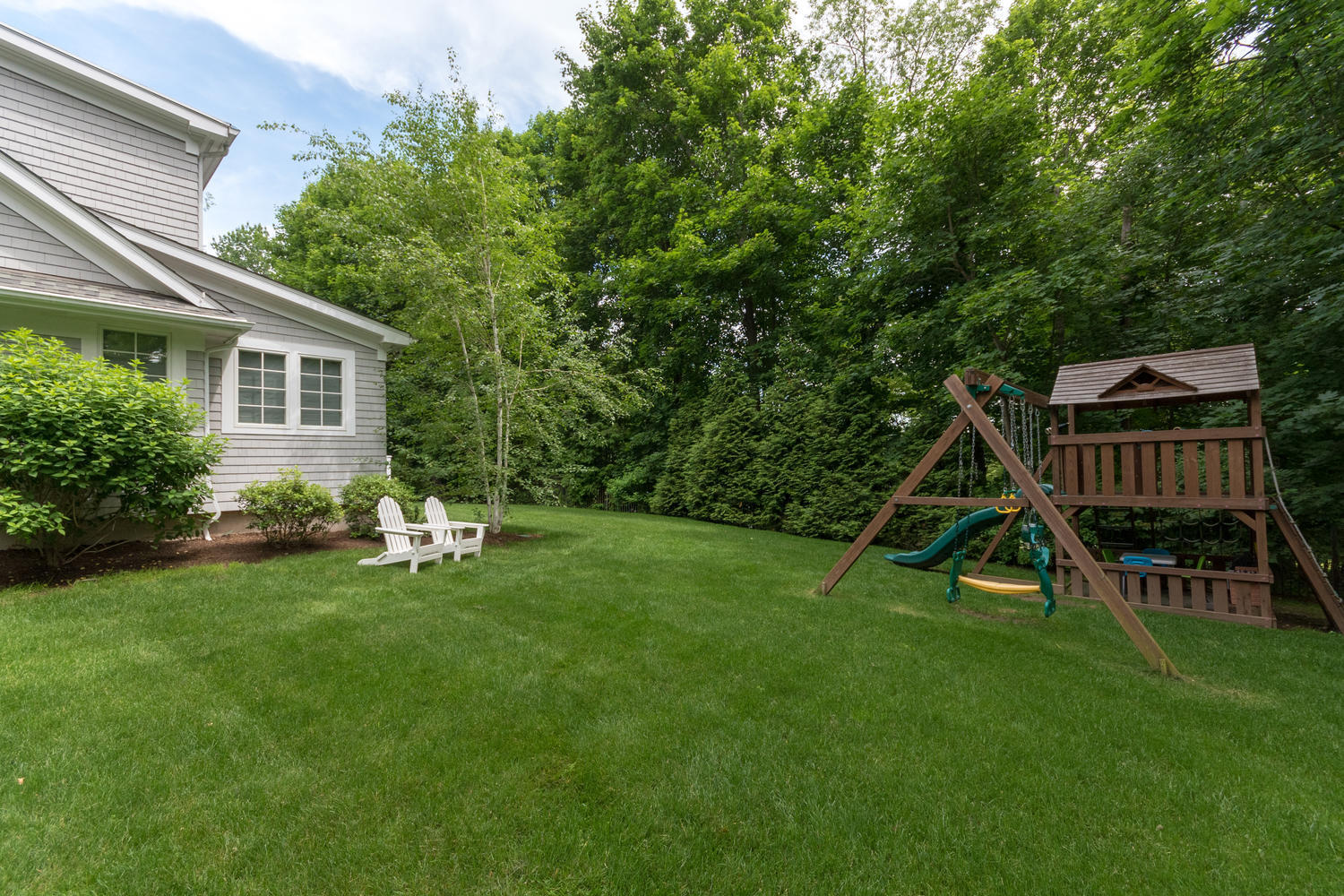 14 Deerfield Road Darien, CT 06820 - Photo 52 of 55 a view of a house with a backyard and a slide