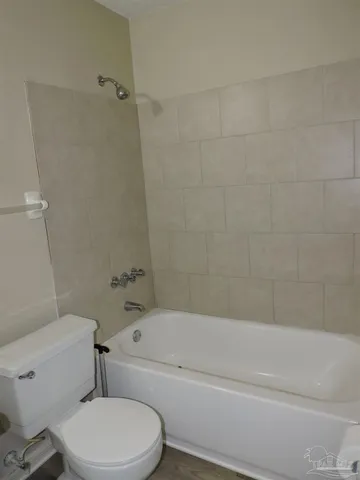 a bathroom with a toilet and a bathtub