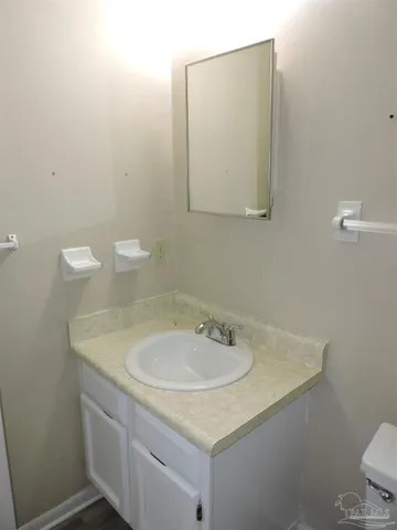 a bathroom with a sink toilet and mirror