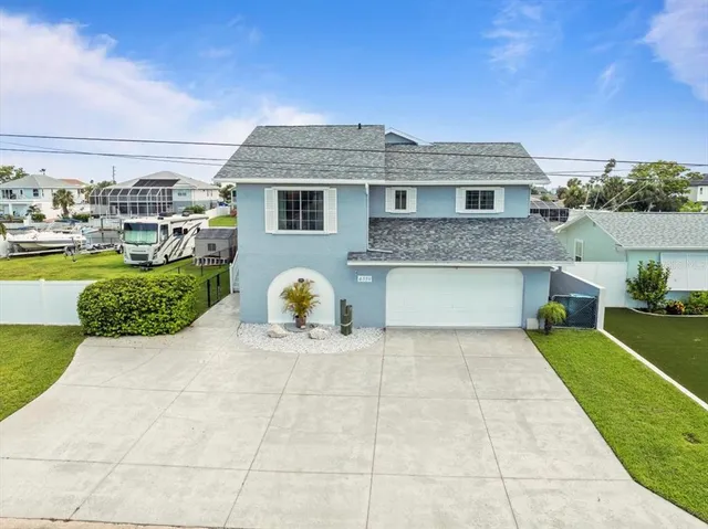 a view of staircase with railing and a chandelier