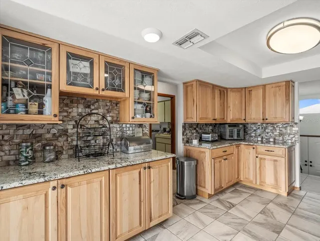 a living room with furniture and large windows