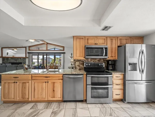 a living room with furniture and kitchen view