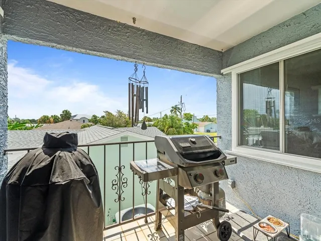 a dining room with furniture water view and a floor to ceiling window