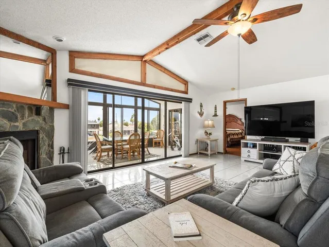 a dining room with furniture and a floor to ceiling window